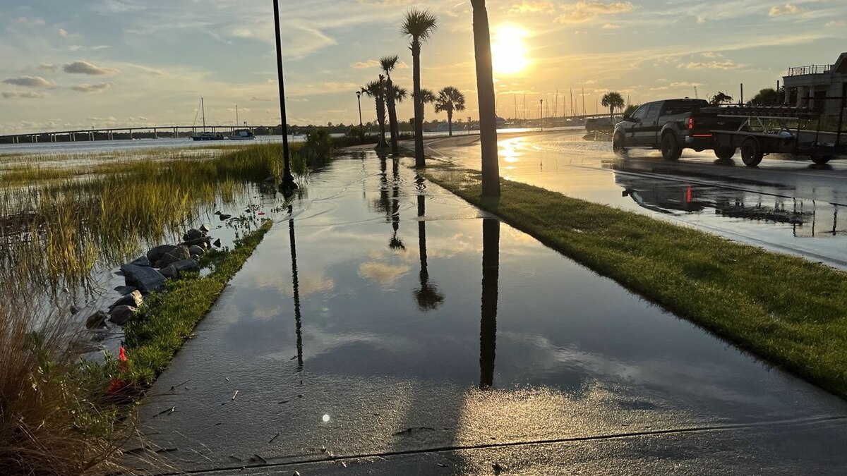 Car driving through a flooded Charleston street after heavy rainfall